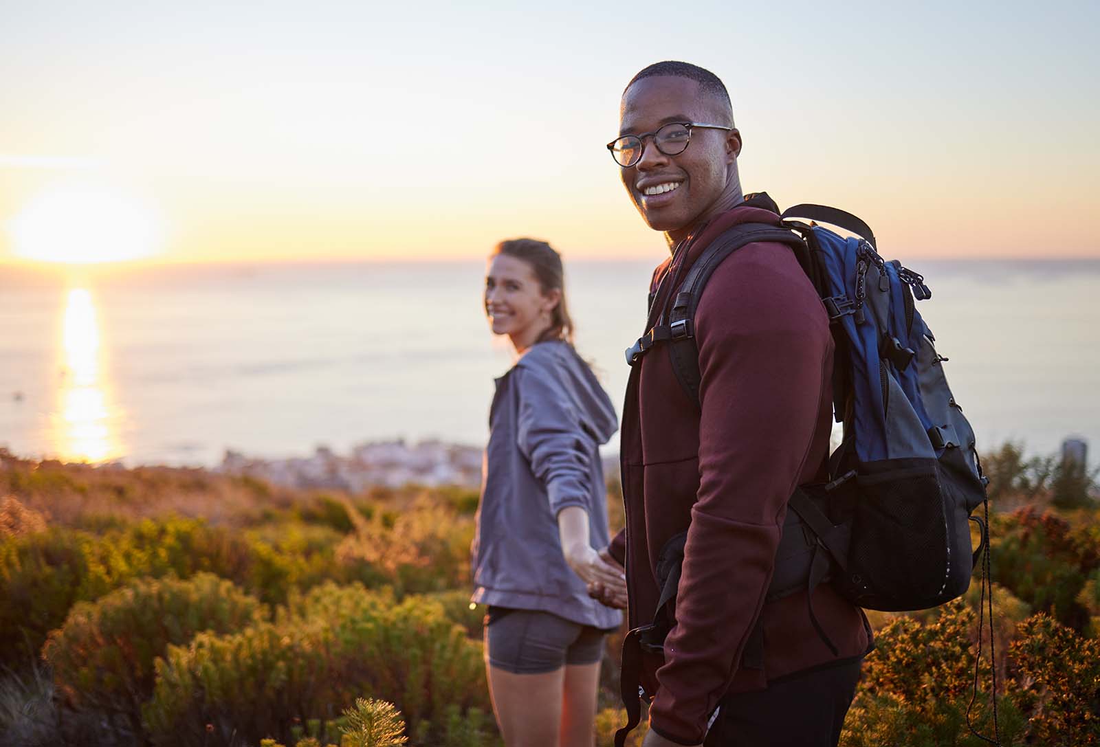 young couple enjoys a hike at sunset Retired bliss on the green: Enjoying active lives pain-free thanks to California Sports & Spine Center.